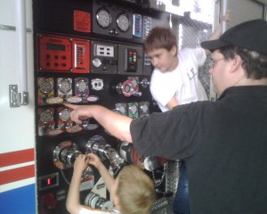 Dad pointing out some of the controls to Ben and James